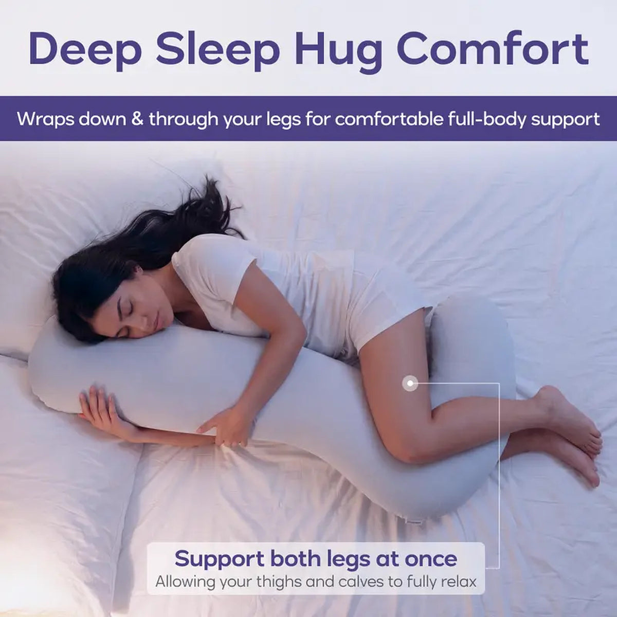 Woman on her side with the body pillow hugged to her chest and wrapped down through her legs