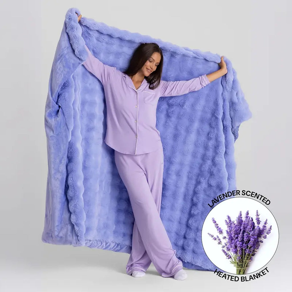 Mochi Mellow Cloud Heated Lavender Throw — Periwinkle throw held open, with the lavender-scented heated blanket badge
