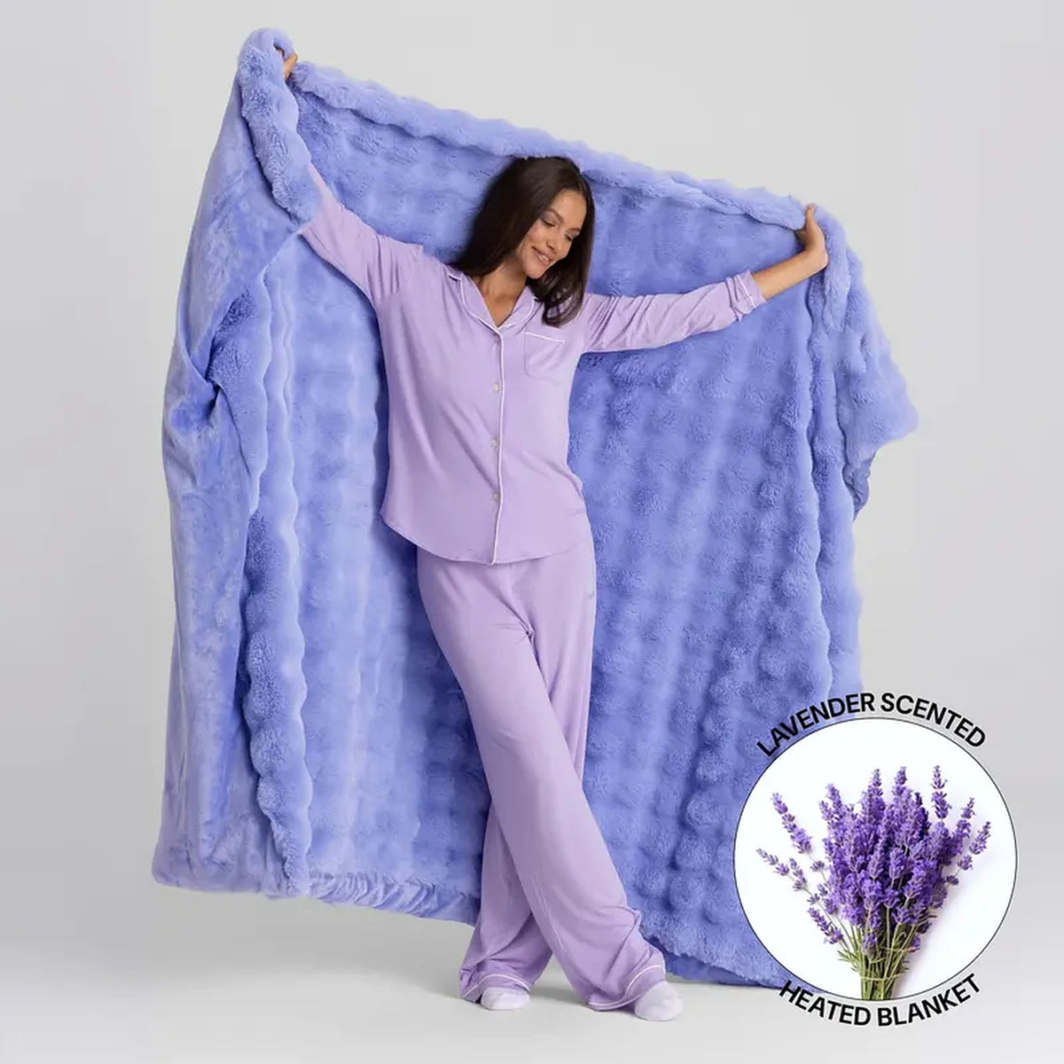 Mochi Mellow Cloud Heated Lavender Throw — Periwinkle throw held open, with the lavender-scented heated blanket badge