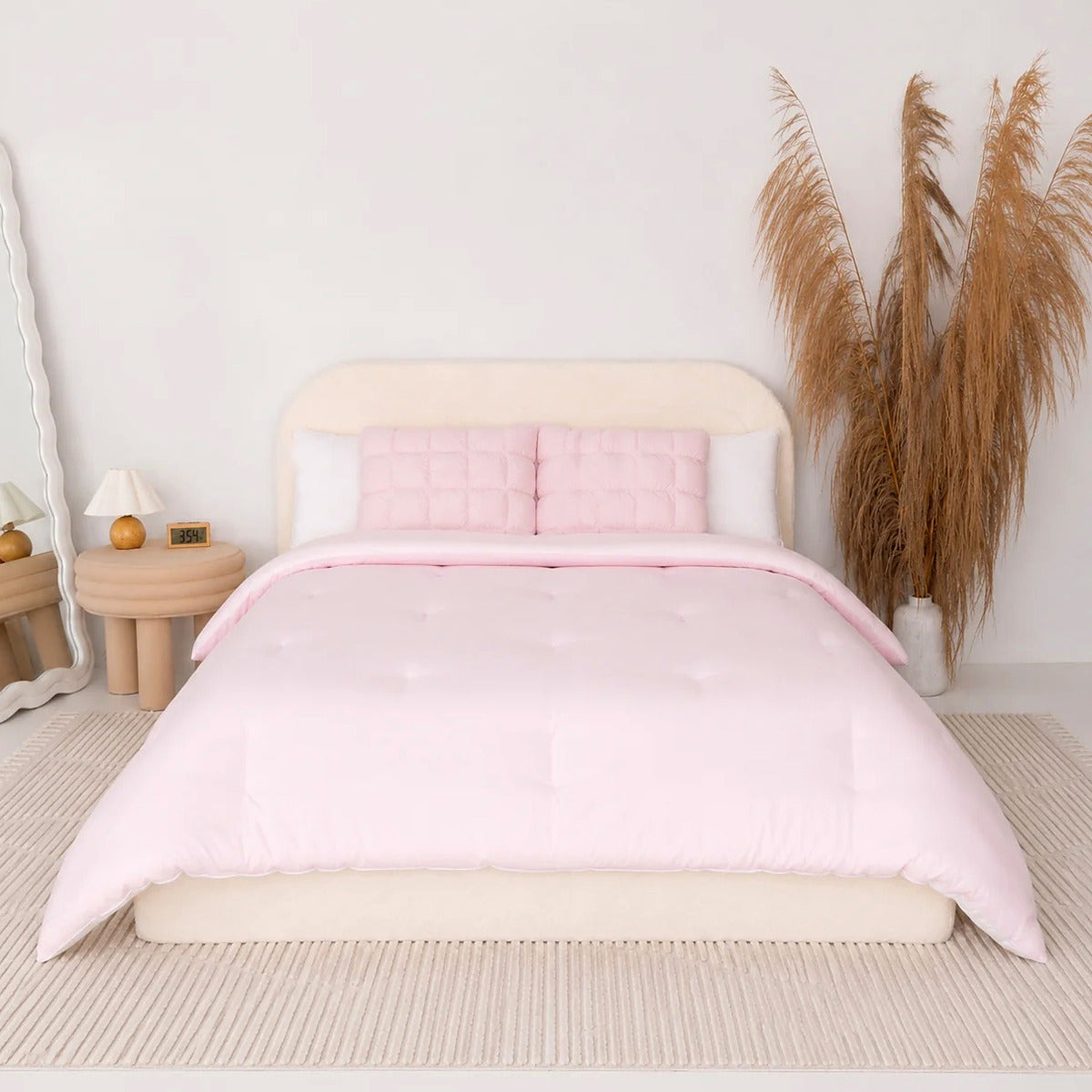 Mochi Mellow Cloud comforter in Pink on a made bed