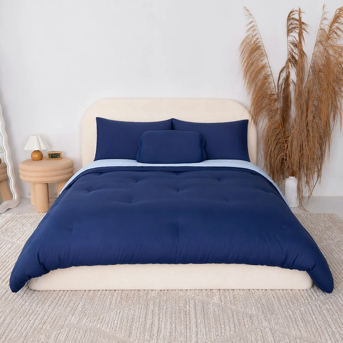 Mochi Mellow Cloud comforter in Navy on a made bed
