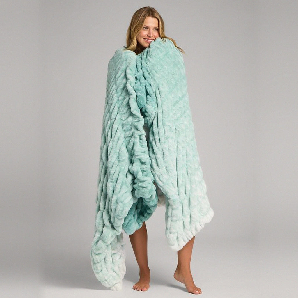 Mochi Mellow Cloud Throw in Mint Ombré — Mint ombré ruched faux-fur throw held around a woman's shoulders, fading to white at the hem