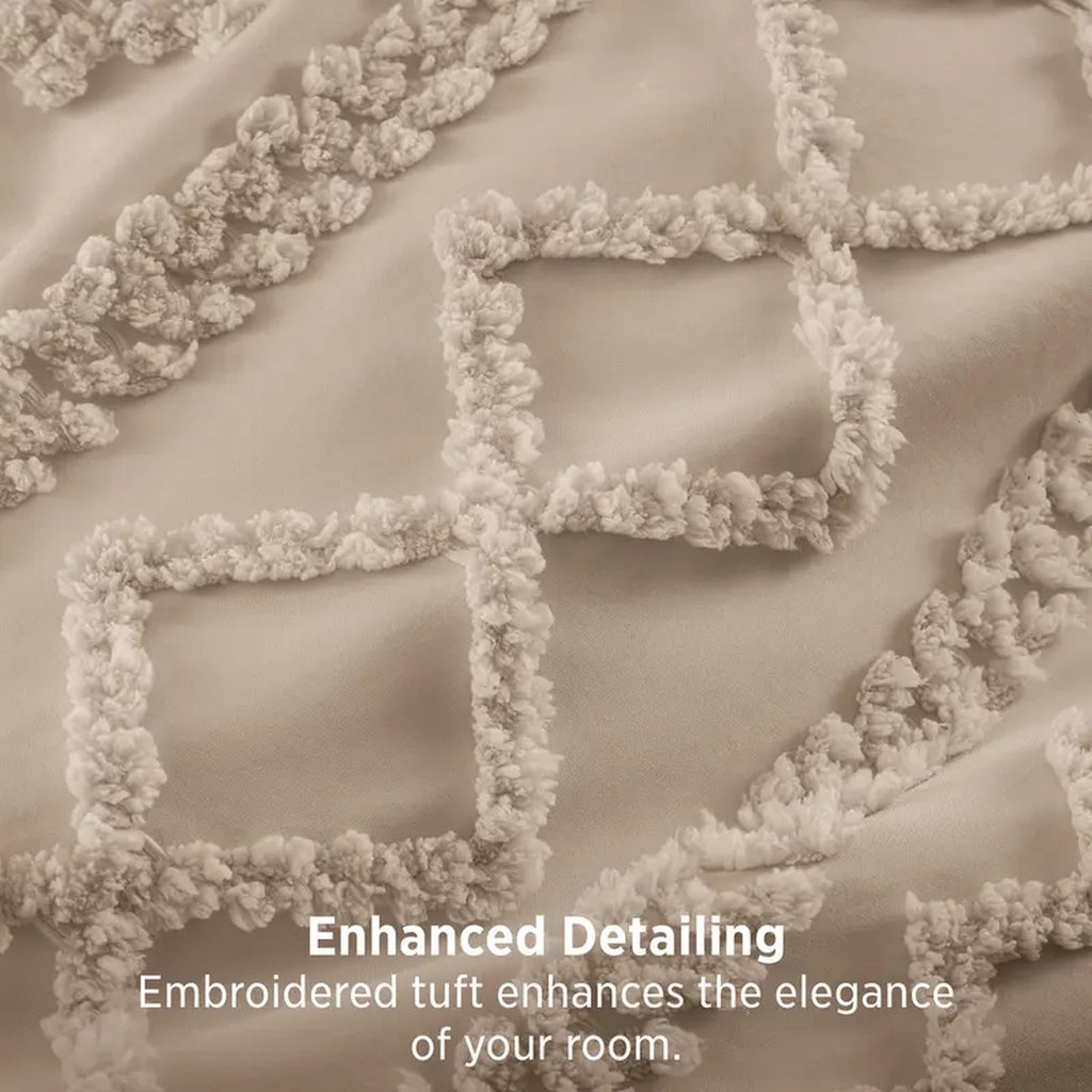 Close-up of the embroidered tuft diamonds on the taupe comforter