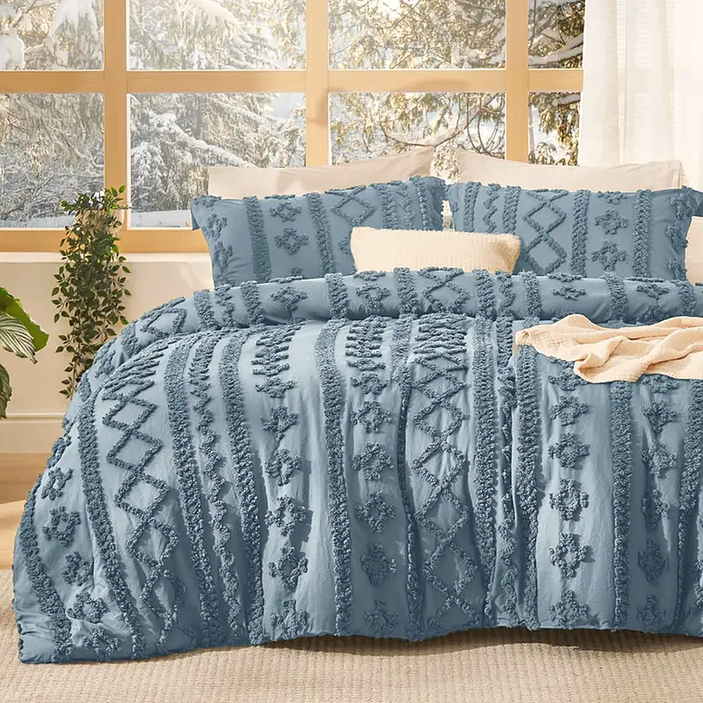 Mochi Mellow Cloud Tufted Comforter Set in Dusty Blue on a made bed, with the two matching tufted pillow shams
