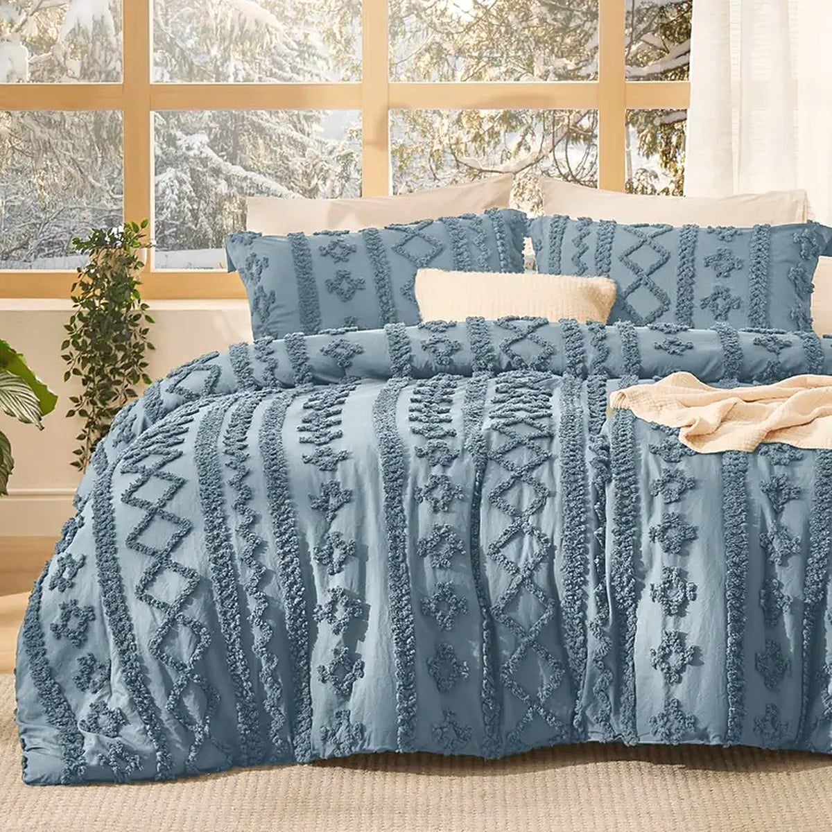 Mochi Mellow Cloud Tufted Comforter Set in Dusty Blue on a made bed, with the two matching tufted pillow shams