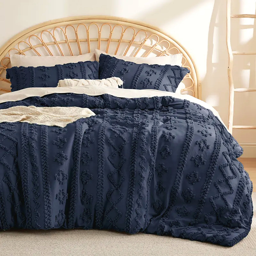Mochi Mellow Cloud Tufted Comforter Set in Navy on a made bed, with the two matching tufted pillow shams