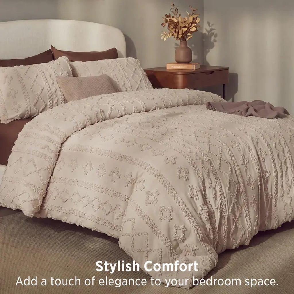 Taupe tufted comforter set on a bed with a wooden nightstand