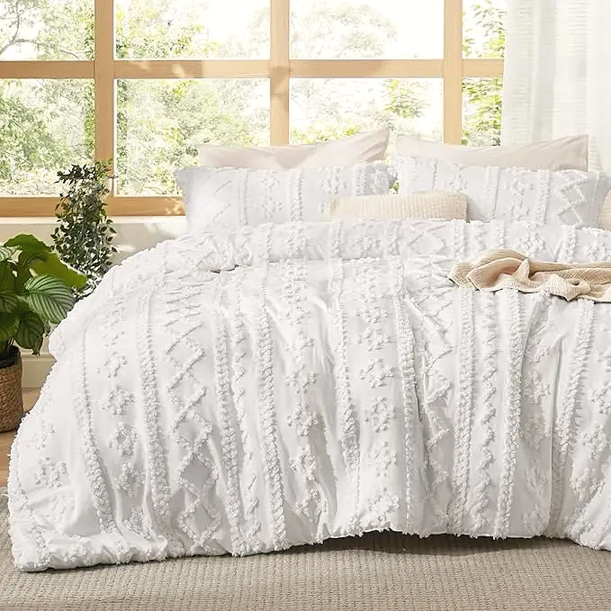 Mochi Mellow Cloud Tufted Comforter Set in White on a made bed, with the two matching tufted pillow shams